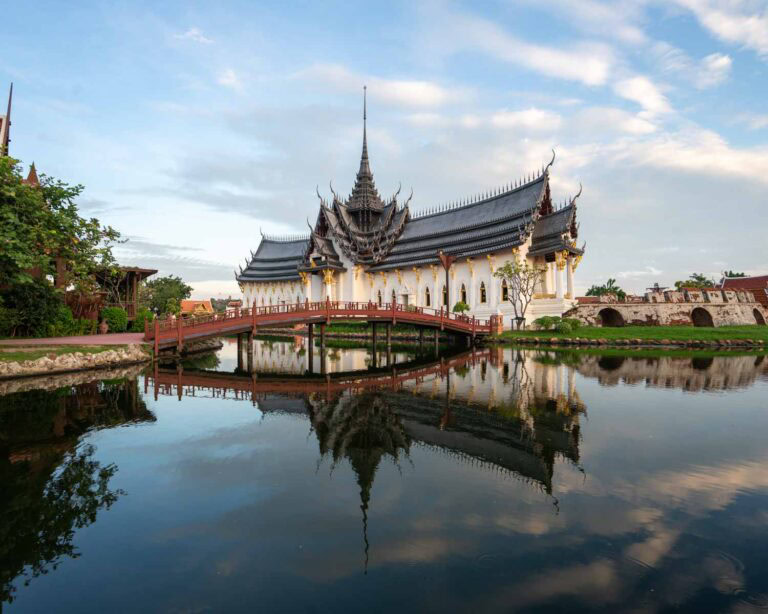A serene temple is reflected in the still water below, creating a nearly perfect mirror image that emphasizes symmetry through reflection. This photo demonstrates how using water can add balance and visual interest in travel photography composition.