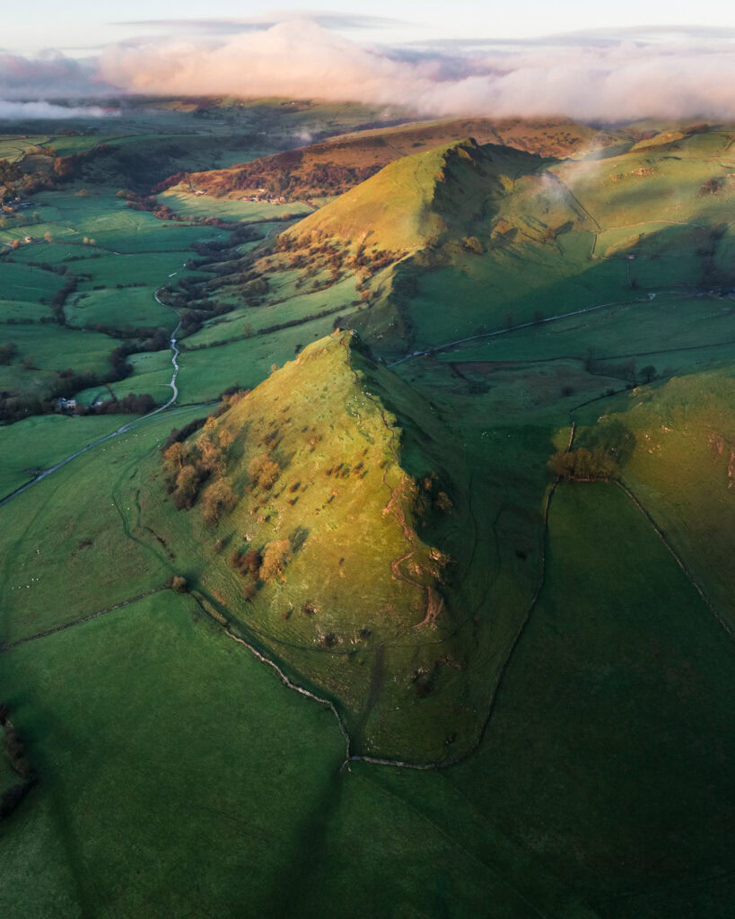 Aerial view of Chrome Hill’s Dragon’s Back ridge rising above patchwork fields in the Peak District